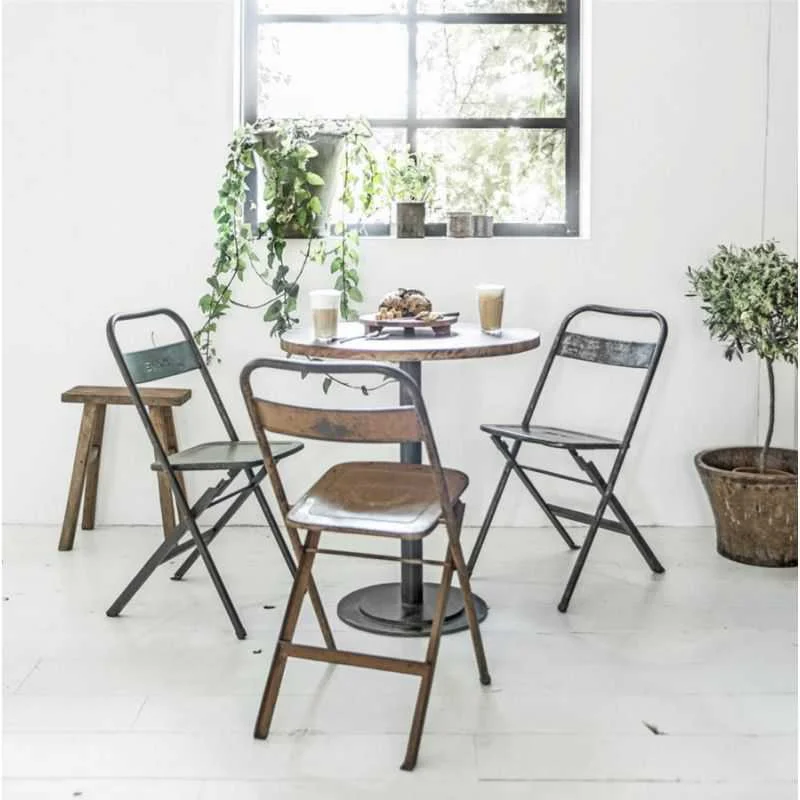 alt=“industrial vintage metal folding chairs”
