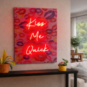 gaming desk with monitor and neon signs backdrop